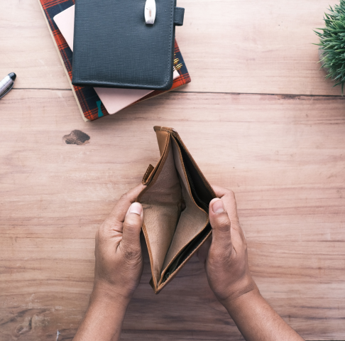 An image of a person holding an empty wallet.