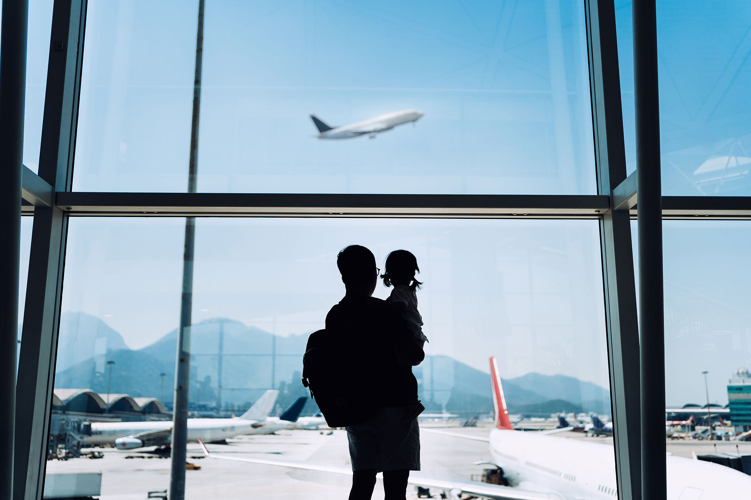 Image of a father and child at the airport